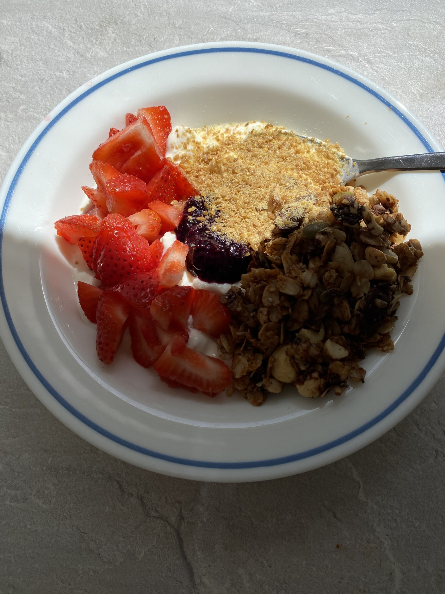 Granola bowl with strawberries, berry compote and flaxseed