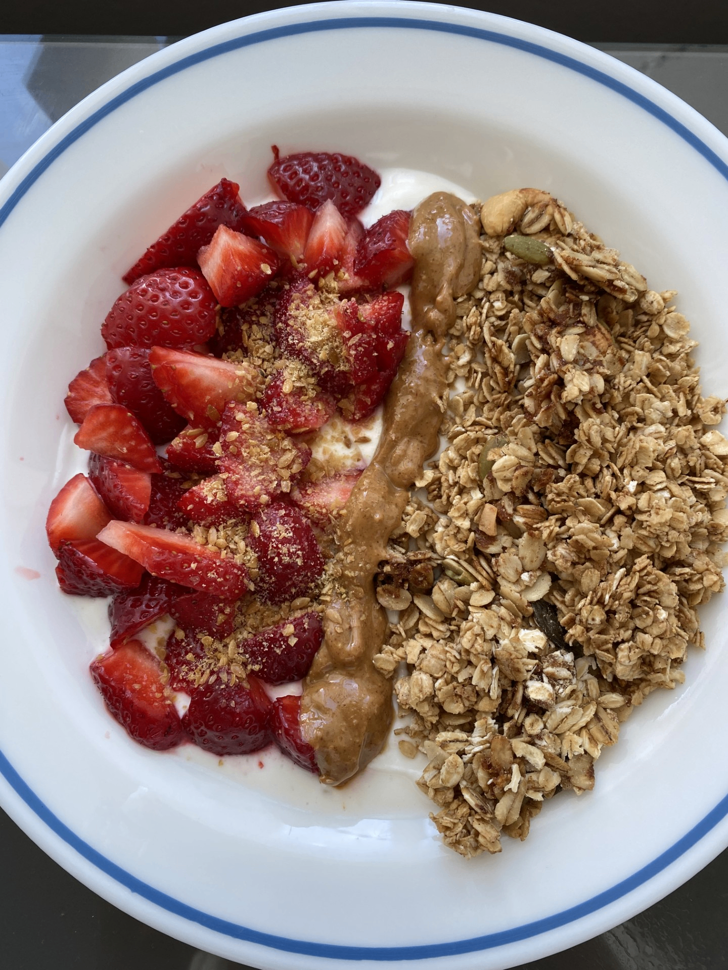 Granola bowl with strawberries, peanut butter and yogurt